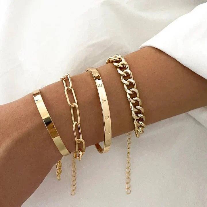 Gold-tone bracelet set with cuff and chain-link bangles on a wrist