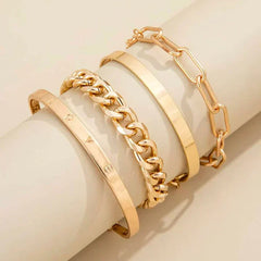 Gold-tone bracelet set with three stacked cuffs and chain-link bracelet details