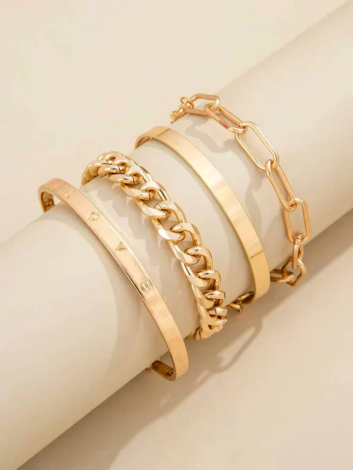 Gold-tone bracelet set with three stacked cuffs and chain-link bracelet details