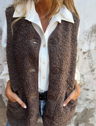 Etta women’s short warm vest in dark brown, button-front with flap pockets.