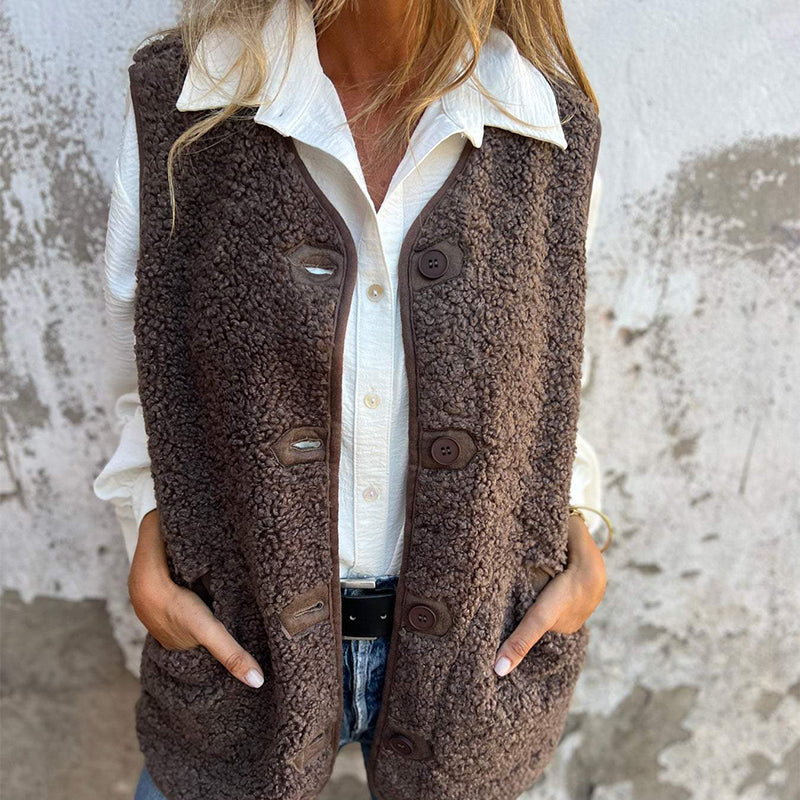 Etta women’s short warm vest in dark brown, button-front with flap pockets.