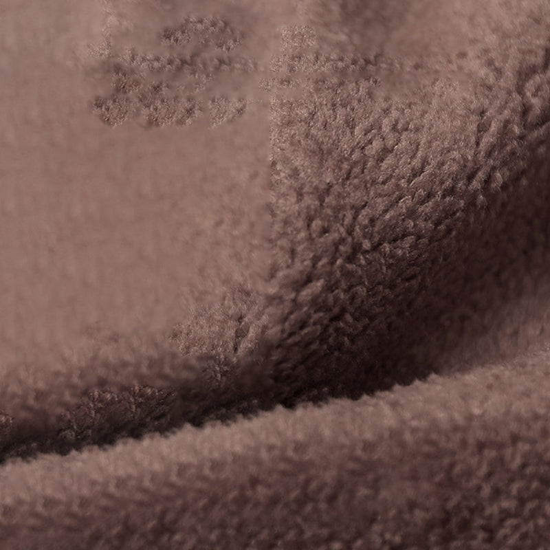 Dark brown sherpa-style vest fabric close-up with textured looped surface.