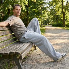 Light grey drawstring sweatpants with elastic waistband and cuffed ankles