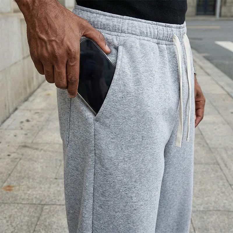 Light grey drawstring sweatpants with side pocket, elastic waistband, and white drawcords