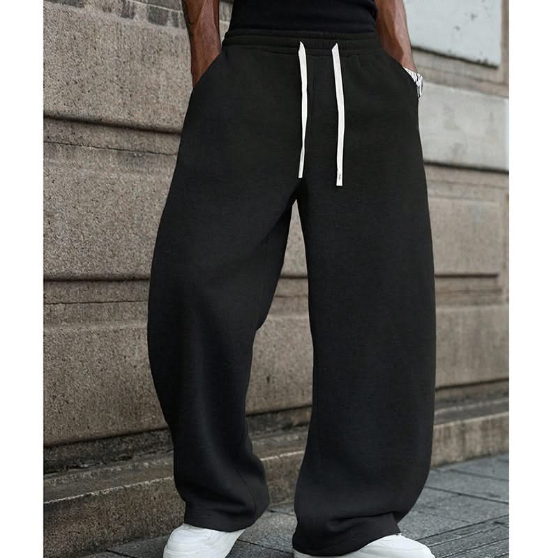 Black drawstring sweatpants with elastic waistband and two white drawcords
