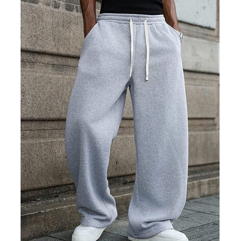 Grey drawstring sweatpants with elastic waistband and two white drawcord ties