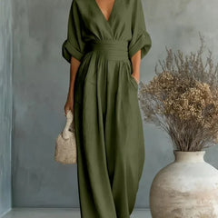 Olive green V-neck high-waisted jumpsuit with gathered waist and wide-leg legs
