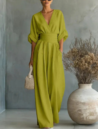 Lime green V-neck high-waisted jumpsuit with draped sleeves and flowy wide-leg pants