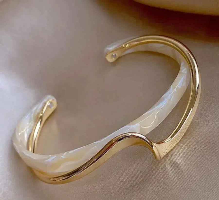 Gold-tone opal stone bracelet with iridescent curved inlay
