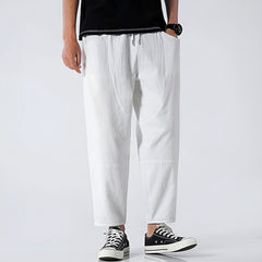 White cropped cotton pants with drawstring waist and cuffed hems